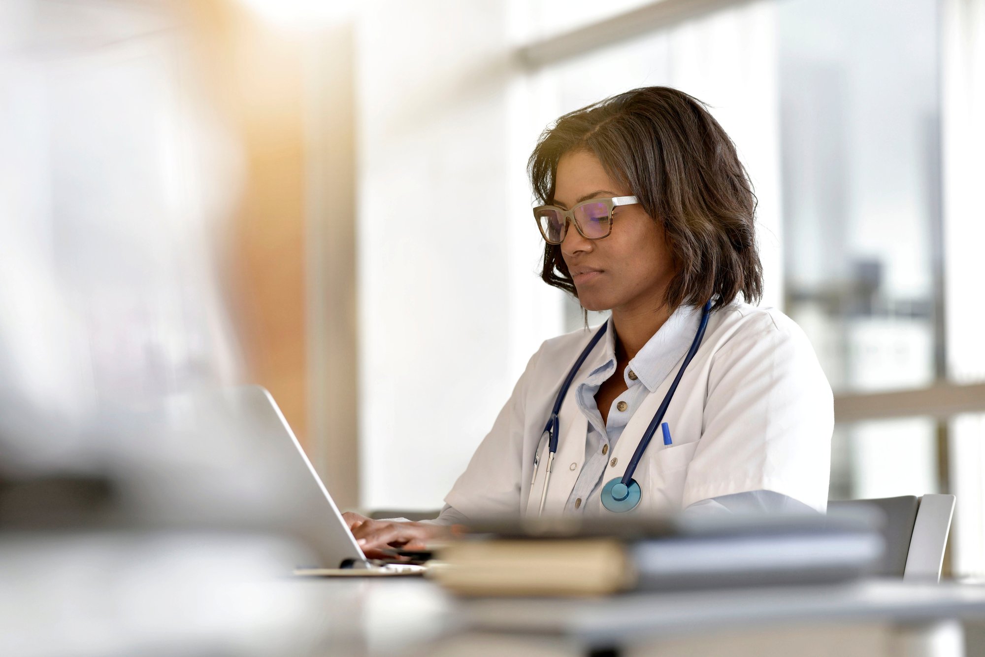 Adventist healthcare worker on a laptop