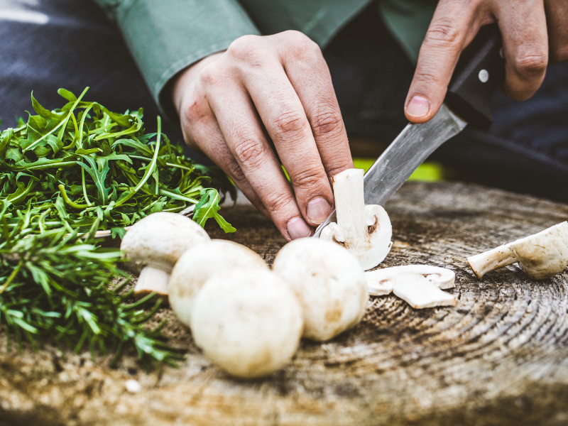 Closeup of someone slicing mushrooms