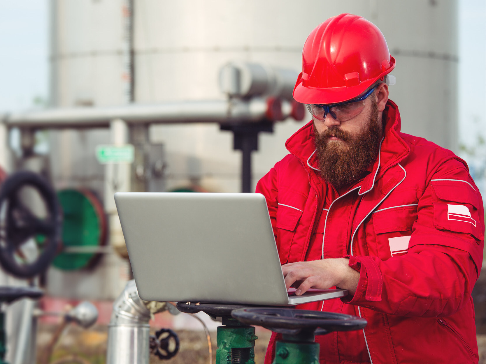 Engineer at an oil refinery using laptop