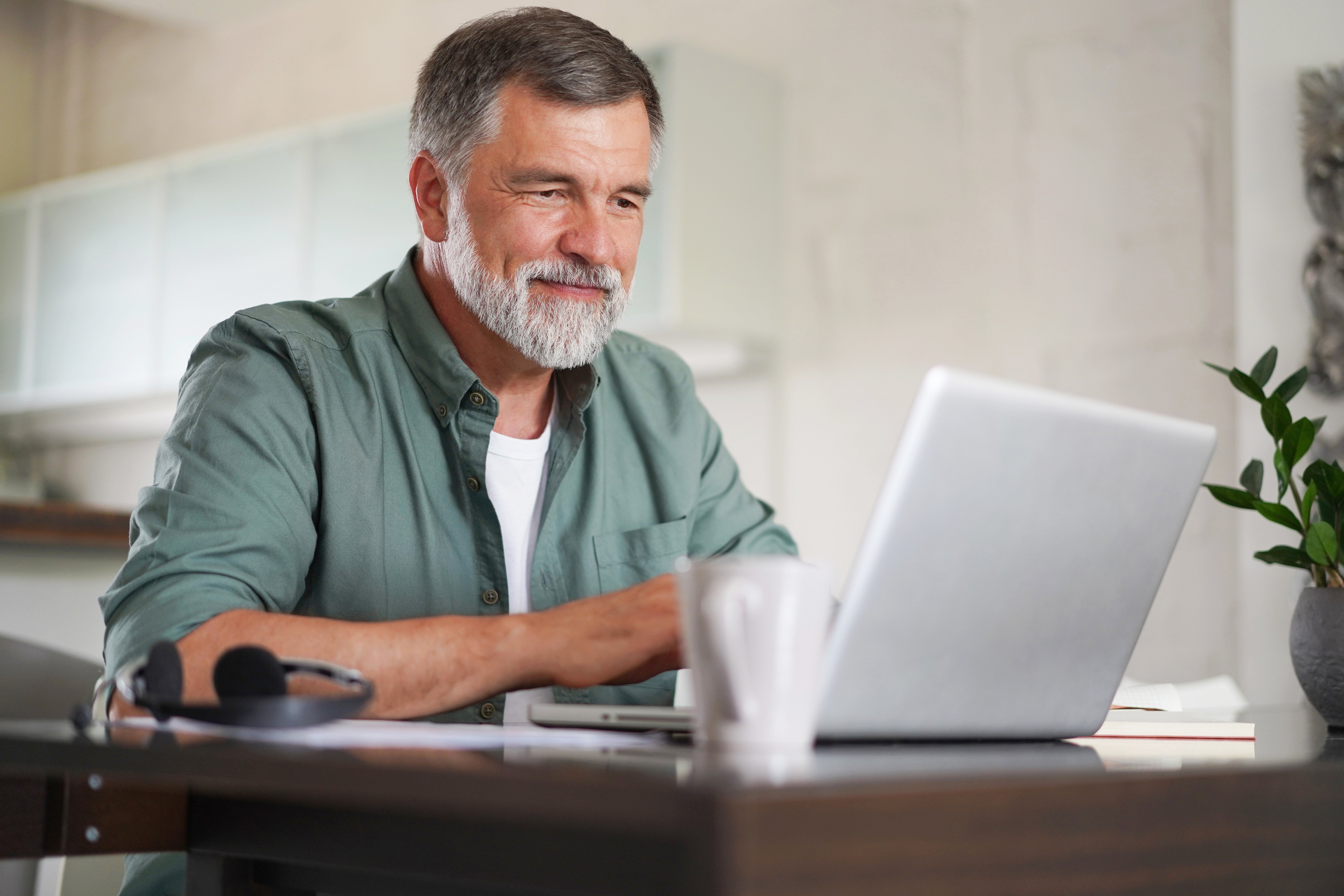 A person sitting at table with laptop