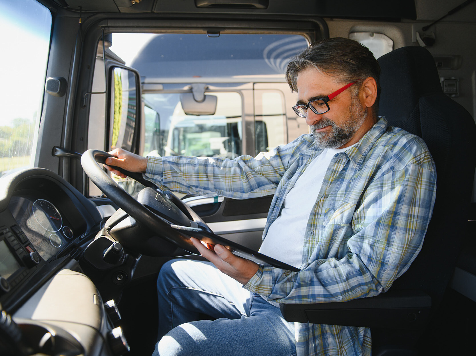 Operations Management_Male trucker driver with tablet