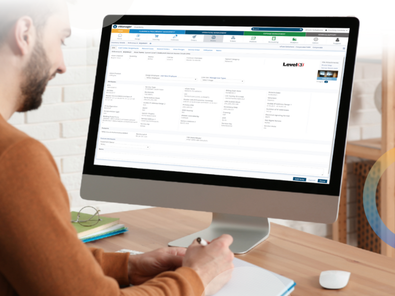 An office worker at a desktop, managing a spreadheet